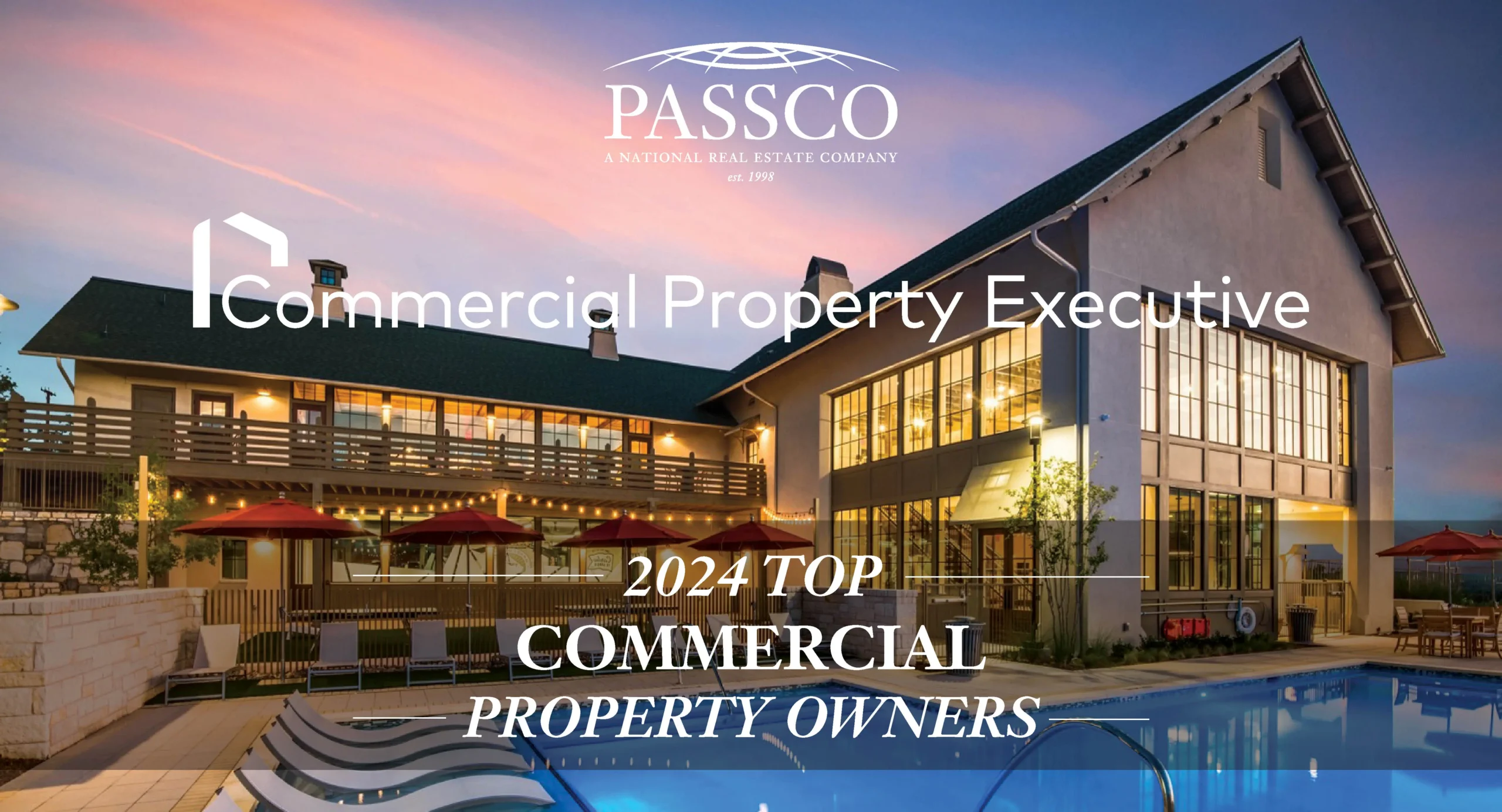 News_Header_CPETop - Passco "2024 TOP COMMERCIAL PROPERTY OWNERS" text superimposed over an image of a large building with multiple levels, patio area, pool, and lounge chairs. The sky is painted with hues of pink and blue, indicating sunrise or sunset.